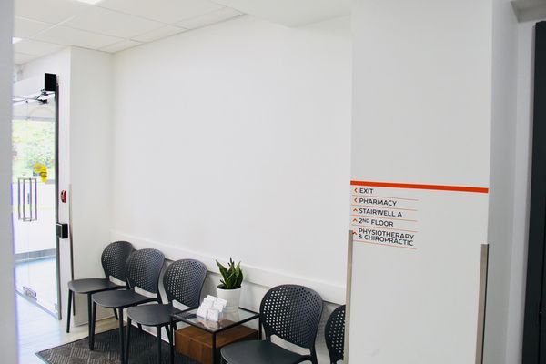 Waiting area with chairs and wayfinding signage