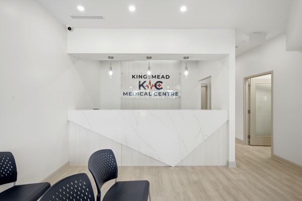 Medical centre reception desk with logo wall