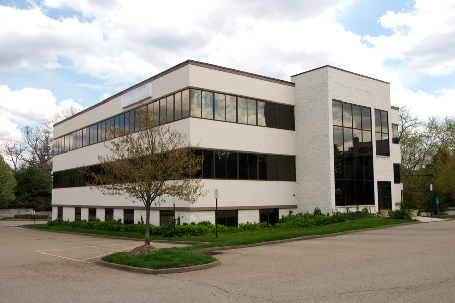 A low-rise medical office building with a parking lot